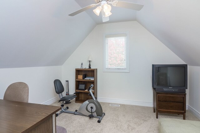 exercise room featuring lofted ceiling, ceiling fan, and carpet floors