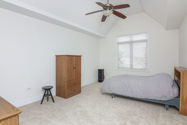 bedroom featuring light colored carpet, vaulted ceiling, and ceiling fan