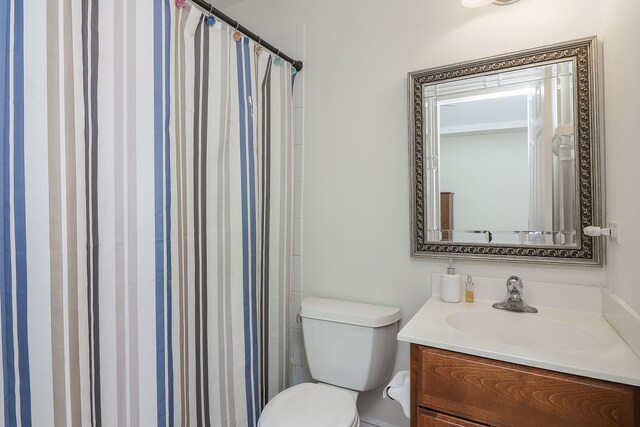 bathroom with vanity, walk in shower, and toilet