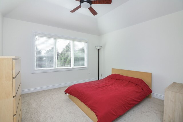 carpeted bedroom featuring ceiling fan and lofted ceiling