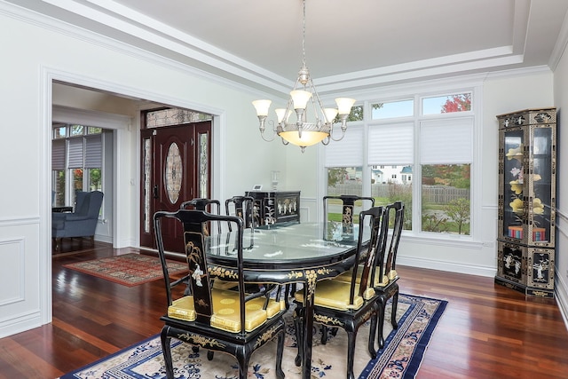 dining area with a healthy amount of sunlight, dark wood-type flooring, and a chandelier