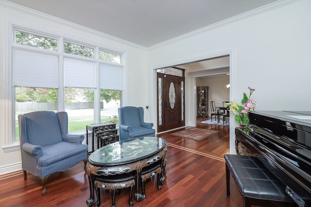 living area featuring crown molding and dark hardwood / wood-style flooring