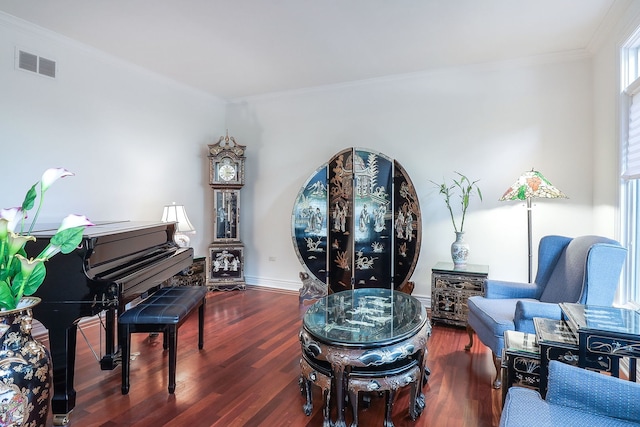 living area featuring dark wood-type flooring and crown molding