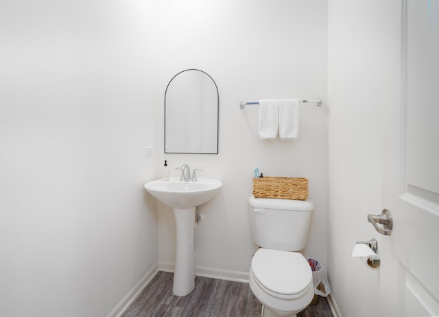 bathroom featuring wood-type flooring, sink, and toilet