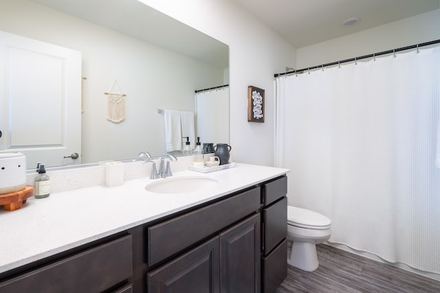 bathroom featuring vanity, toilet, and hardwood / wood-style flooring