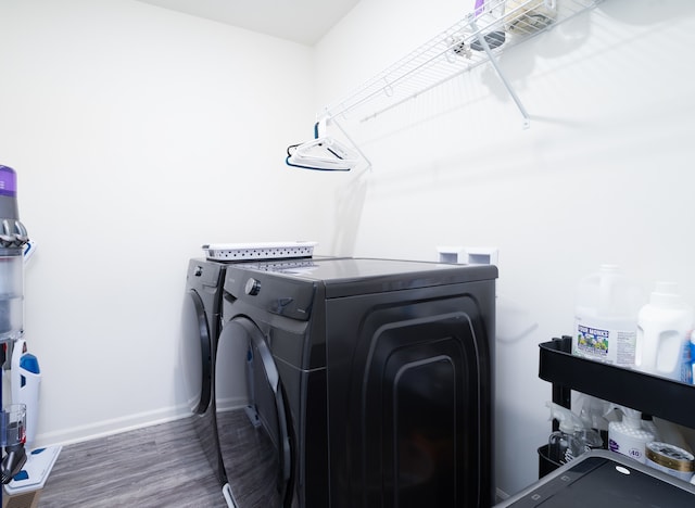 laundry area featuring dark hardwood / wood-style floors and washing machine and dryer