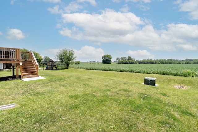 view of yard featuring a rural view and a wooden deck