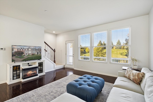 living room featuring a wealth of natural light and dark hardwood / wood-style floors