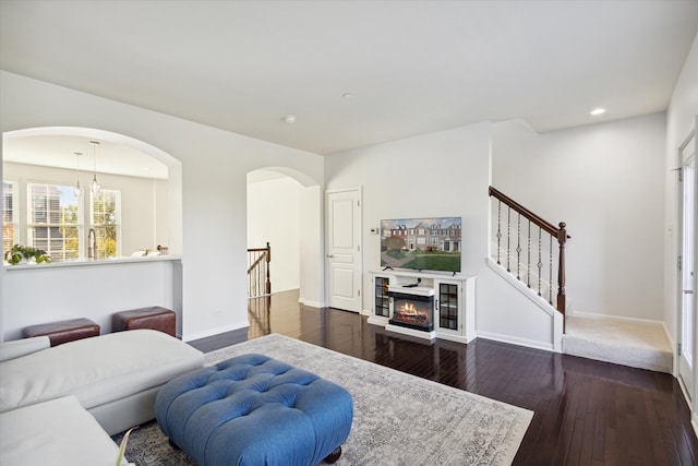 living room featuring dark hardwood / wood-style floors and a chandelier