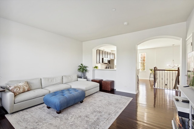 living room with an inviting chandelier and hardwood / wood-style flooring