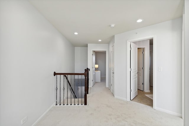 hallway with light colored carpet