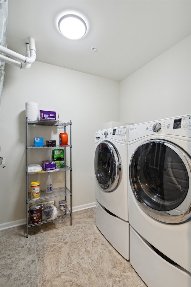 washroom featuring washing machine and clothes dryer