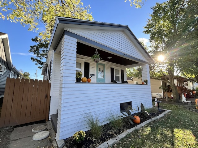 bungalow-style home featuring a porch and fence