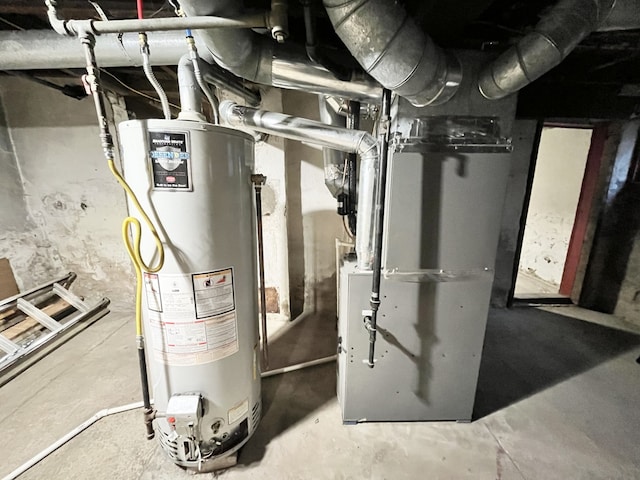 utility room with heating unit and water heater