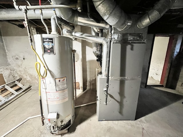utility room featuring water heater and heating unit