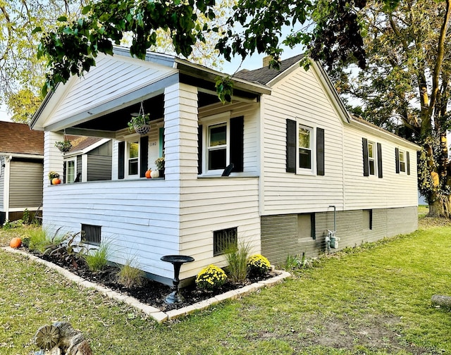 view of property exterior with a lawn