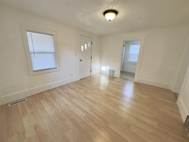 entryway with visible vents, baseboards, and light wood-type flooring
