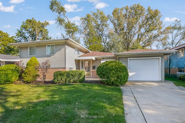 tri-level home with a garage and a front yard