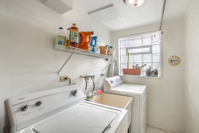 laundry area with separate washer and dryer and crown molding