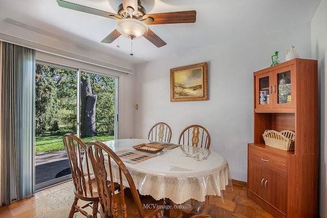 dining room with ceiling fan and light parquet floors