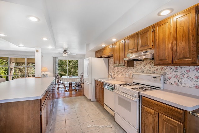 kitchen featuring ceiling fan, sink, light tile patterned floors, and white appliances