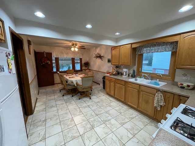 kitchen featuring ceiling fan, white appliances, and sink