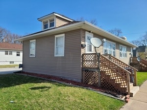 view of side of home featuring a lawn