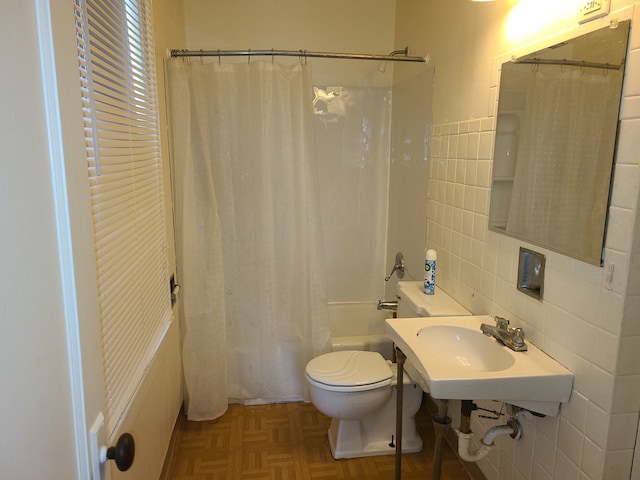 bathroom featuring parquet flooring, tile walls, shower / tub combo, and toilet