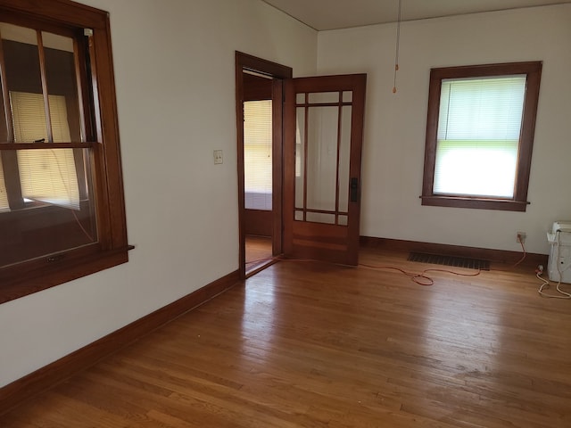 unfurnished room with wood-type flooring