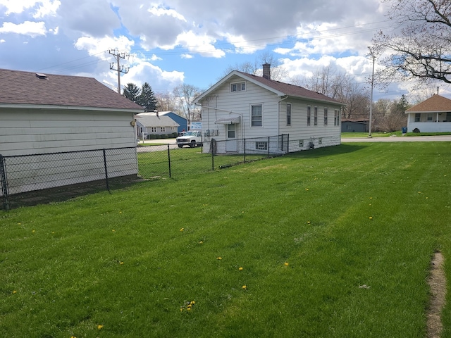 back of property featuring a lawn