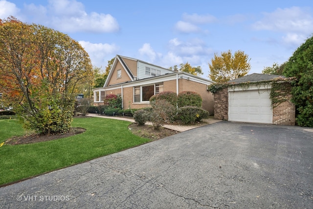 view of front of home with a front lawn and a garage