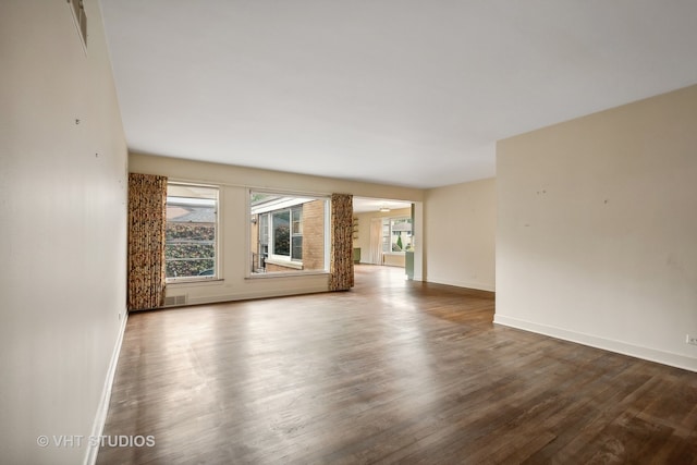 unfurnished living room with wood-type flooring