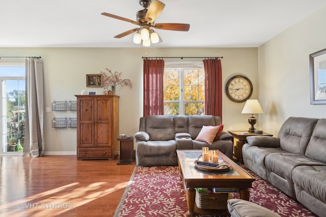 living room featuring wood-type flooring and ceiling fan