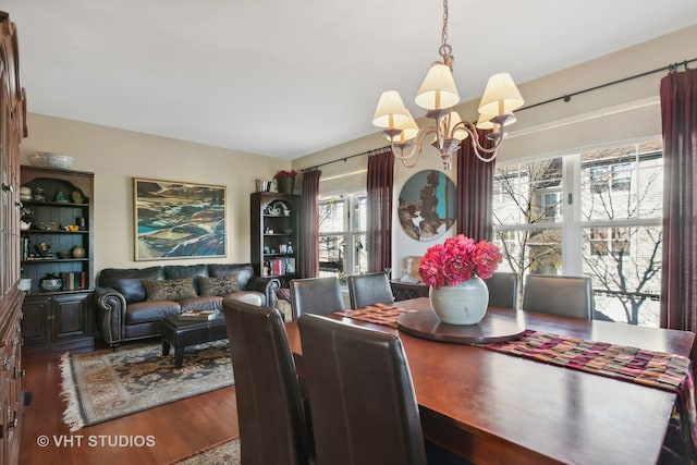 dining space with an inviting chandelier, dark wood-type flooring, and a healthy amount of sunlight