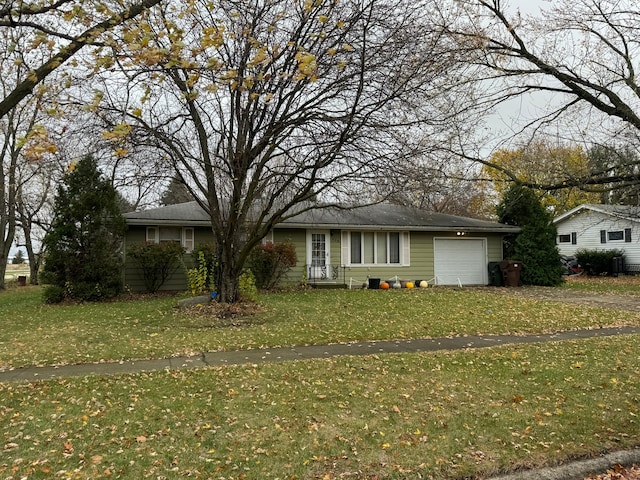 view of front of property featuring a garage and a front lawn