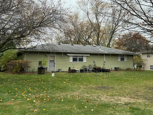 rear view of house with a yard