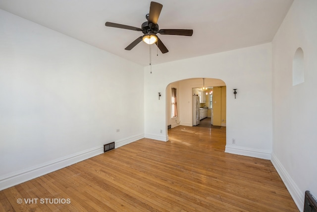 unfurnished room featuring ceiling fan and hardwood / wood-style flooring