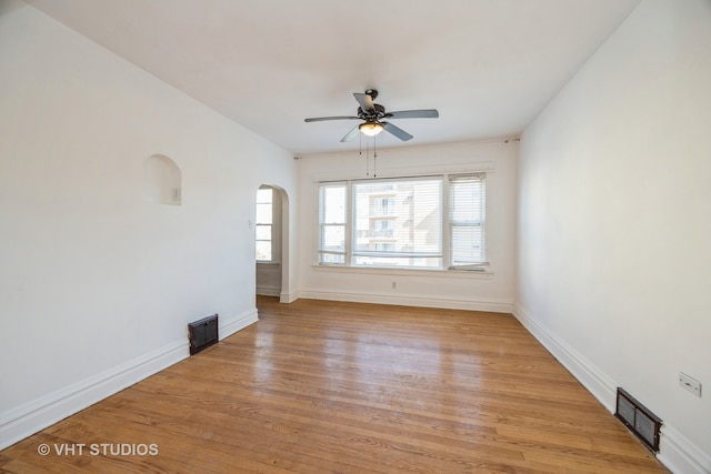 empty room with light wood-type flooring and ceiling fan