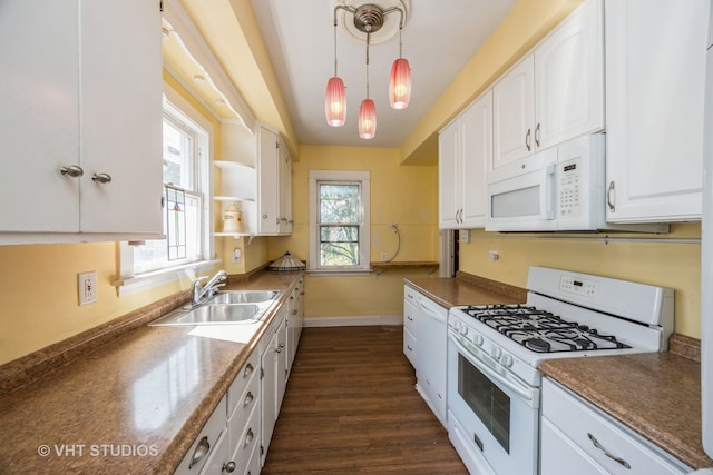 kitchen featuring white appliances, dark hardwood / wood-style flooring, decorative light fixtures, white cabinets, and a wealth of natural light