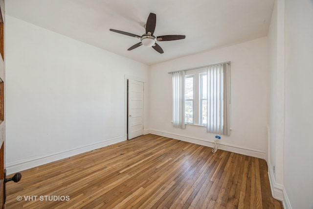 empty room featuring ceiling fan and hardwood / wood-style floors