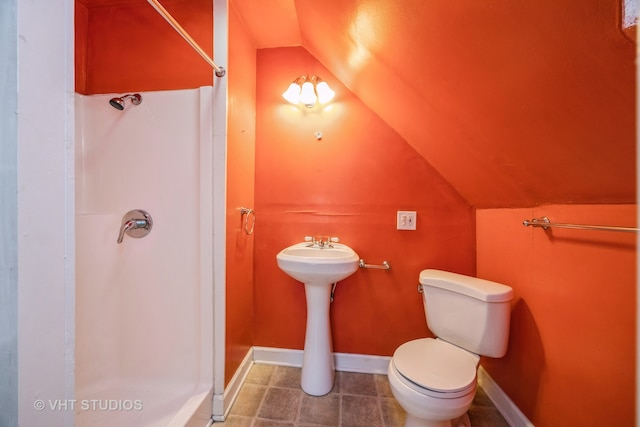 bathroom featuring lofted ceiling, walk in shower, and toilet