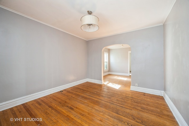 spare room featuring ornamental molding and hardwood / wood-style flooring