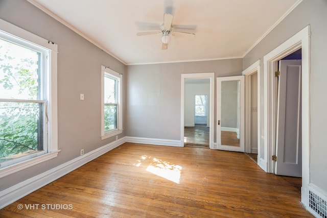 interior space featuring ceiling fan, plenty of natural light, hardwood / wood-style floors, and ornamental molding