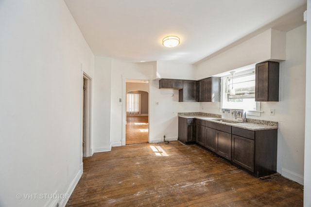 kitchen featuring dark brown cabinets, dark hardwood / wood-style floors, and sink