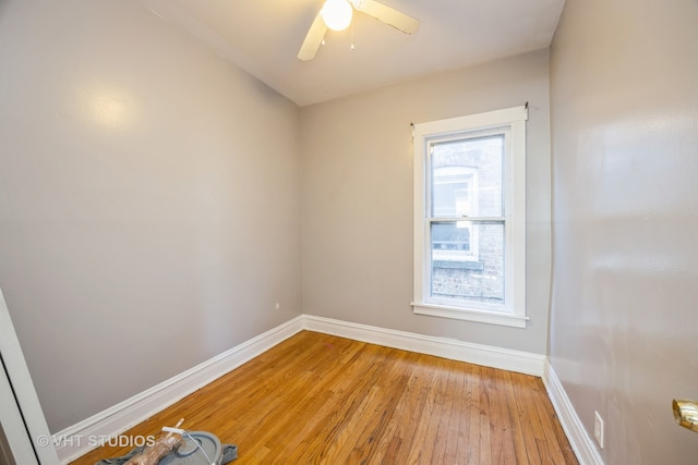 empty room with ceiling fan and light hardwood / wood-style flooring