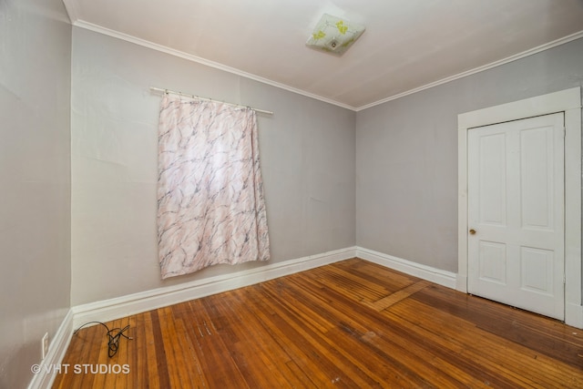 unfurnished room featuring hardwood / wood-style flooring and crown molding