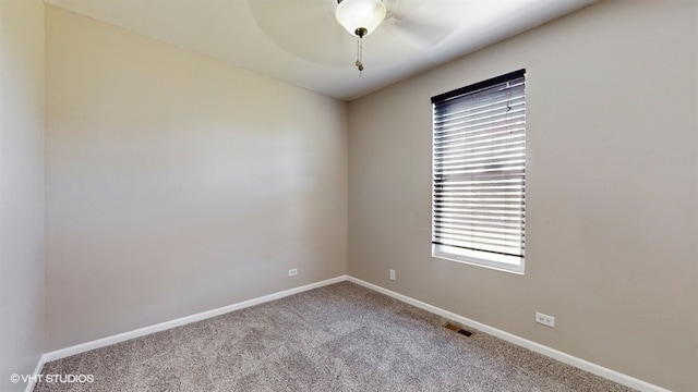 carpeted empty room featuring ceiling fan