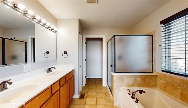 bathroom with tile patterned flooring, vanity, and independent shower and bath