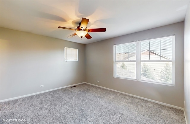 spare room with ceiling fan and carpet flooring