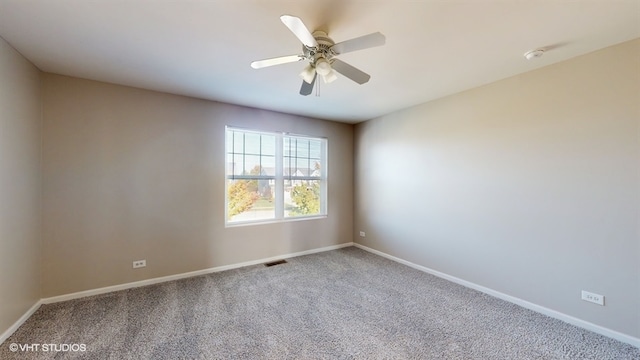 spare room featuring ceiling fan and carpet flooring